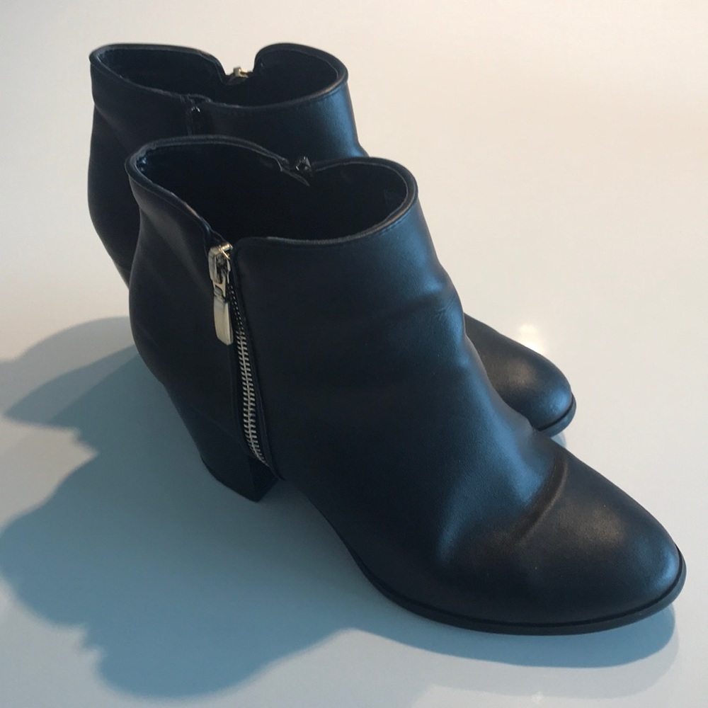 Black and gold zipper booties.